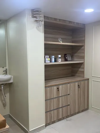 This is a section of our treatment room, showing the organized storage for medical supplies and the patient examination bed. We ensure every aspect of our facility supports effective and safe hair treatments.