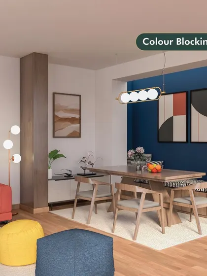 This living and dining area demonstrates the color blocking style. We used bold blocks of blue, orange, and yellow alongside neutral wood tones to create a playful, modern, and energetic space.