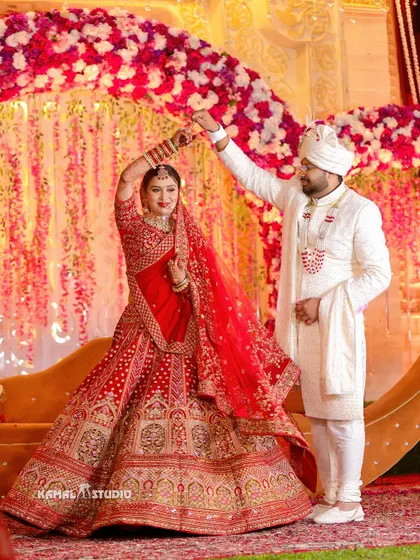 A joyful shot of the couple dancing together on stage after their Varmala ceremony.