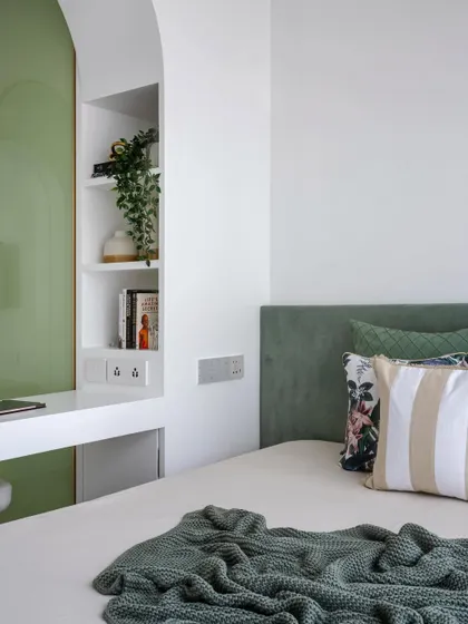 This teen daughter's bedroom is a multifunctional oasis with a sleek platform bed and an arched divider that separates the wardrobe and sleeping areas, providing both privacy and style.
