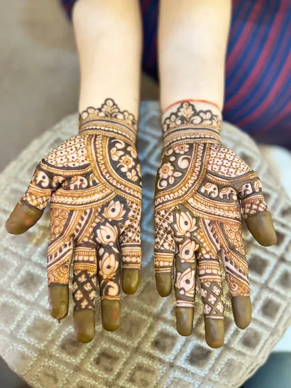 A more traditional, full-palm design for Teej, with elephant and lotus motifs.