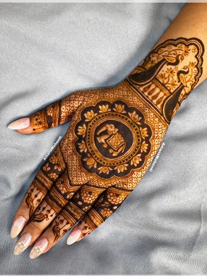 A beautiful back-hand design with a central mandala holding a ceremonial elephant. The use of dark-filled space makes the intricate details stand out.