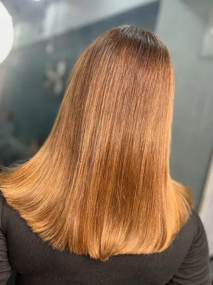The back view of this sleek, golden blonde look. The color is vibrant and the finish is incredibly smooth and shiny.