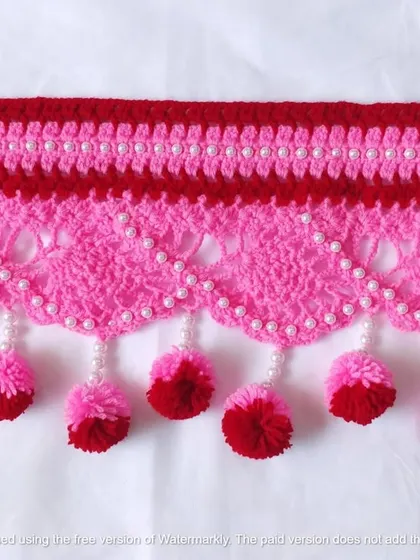 This pink and red toran with pearl details is a beautiful example of a custom piece made with love.
