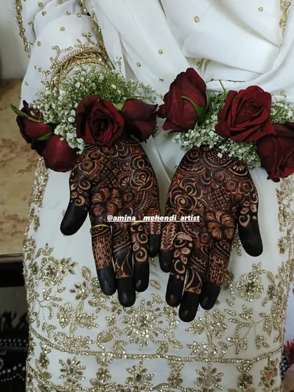 A close-up of the bride's hands with floral bracelets, showcasing the beautiful simplicity of the palm design.