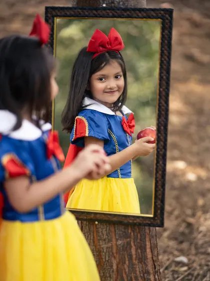 Mirror, mirror on the wall. This creative shot with a mirror adds a classic storytelling element to our Snow White photoshoot.