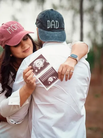 A creative and sweet announcement photo. The "Mom" and "Dad" caps and the ultrasound picture make this a unique and personal memory.