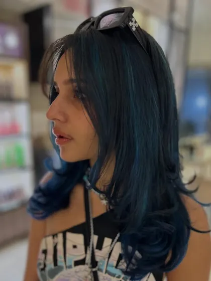 A cool and edgy look with this deep blue color. The layered cut adds texture and movement, making the creative color even more dynamic.