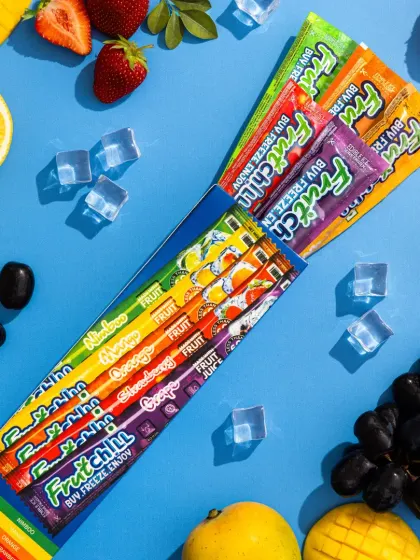 A fun and refreshing flatlay for Fruitchill. We arranged the multi-flavor pack with fresh fruits and ice cubes on a bright blue background to create a cool, summery vibe.