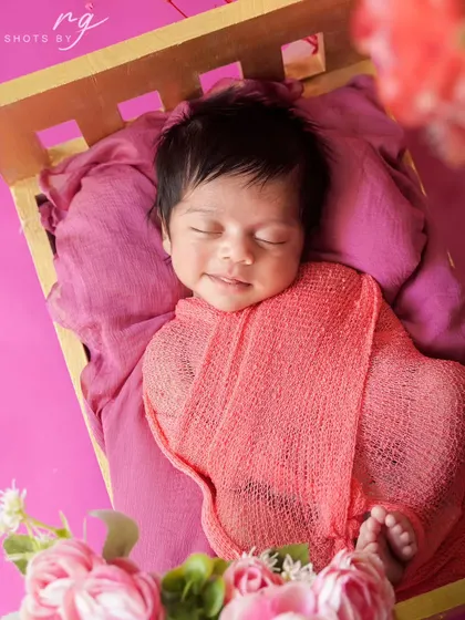 A precious, sleepy smile from a newborn girl. These are the magical, fleeting moments we aim to preserve for your family forever.