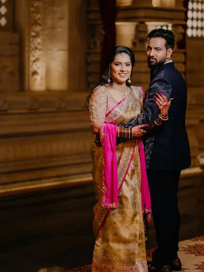 A classic pose capturing the elegance of the bride's reception attire and her flawless makeup.