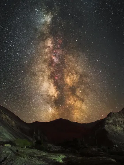 The Milky Way over Lamayuru in Ladakh. The region is famous for its ancient monastery and unique "moonscape" geological formations, providing a surreal foreground for night sky photography.