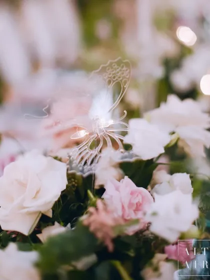 A delicate glass butterfly detail nestled within a floral arrangement at our Bali wedding. These small, whimsical touches add a layer of magic to the design.