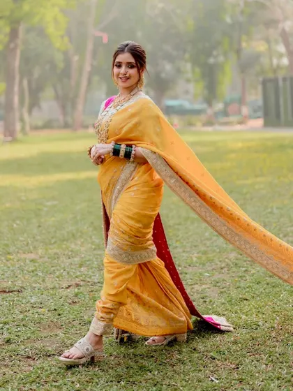 The flowing saree in this shot adds a sense of movement and grace. The full-length view shows how the makeup and styling come together to create a cohesive and stunning bridal look.