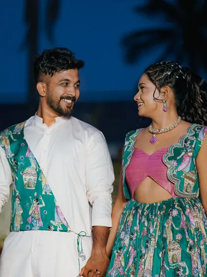 A candid moment from my mehendi ceremony, with my husband and I in coordinated outfits.