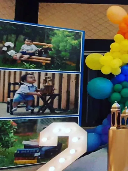 Personalization is key. For this Cocomelon party, I included a large photo board displaying pictures of the birthday boy, alongside a light-up number '2' to mark the milestone.