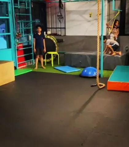 A wide view of our training space in Jaynagar. You can see the padded floors, climbing ropes, and other equipment we use to create a versatile and safe training ground for kids.