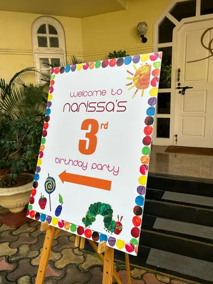 Welcome to the party. I coordinate with decorators to ensure my food setup, including signage, matches the overall theme, like this 'Very Hungry Caterpillar' birthday.