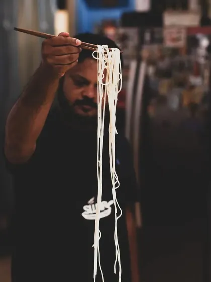 A student proudly displays the hand-pulled noodles made during our class. There's nothing like the taste and texture of fresh, homemade noodles.