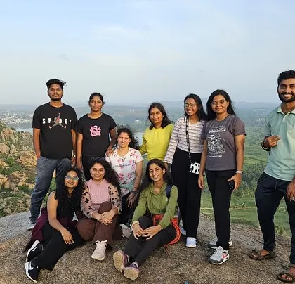 A group of friends enjoying the sunset views from Kunti Betta.