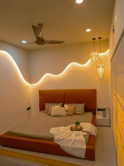 A wider angle of the 'Sukoon' bedroom, showing the balance between the warm, rust-colored bed and the neutral, wavy walls.