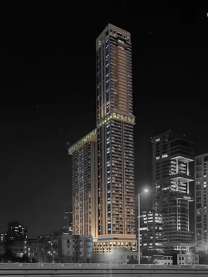 A dramatic night view of our South Mumbai residential project. The illuminated structure showcases its elegant form, with high-performance glass reflecting the city lights while hinting at the sophisticated urban living within.