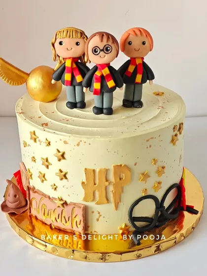 This Harry Potter cake was for a magical 10th birthday. It features the golden snitch, the marauder's map, and the iconic HP logo, all set against a starry, spellbinding design.