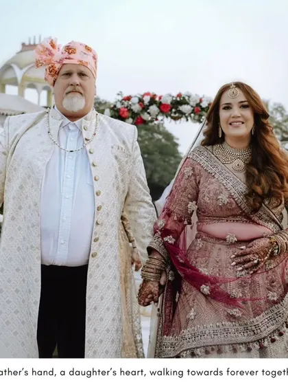 A touching moment between the bride and her father as they walk hand-in-hand, a beautiful symbol of love and support.