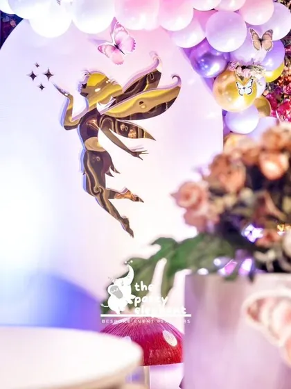 A golden fairy cutout appears to be sprinkling magic stars, a beautiful detail that adds to the enchanting atmosphere of the party.