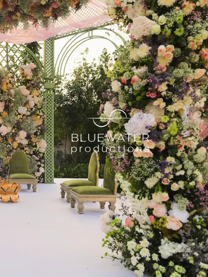 A close-up of the dense floral pillars of the mandap, showcasing the soft pastel color palette.