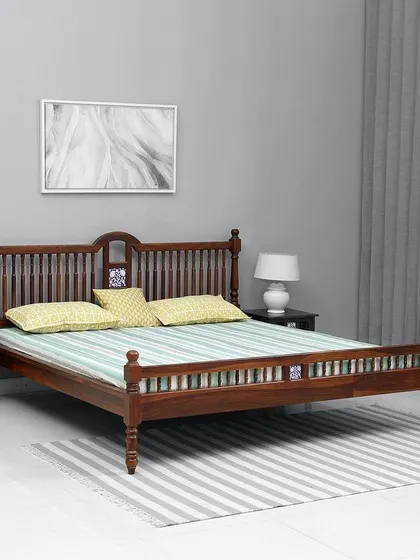 This is a classic wooden bed we crafted from solid Sal wood. The design features traditional turned legs and a spindle headboard and footboard, offering a timeless and sturdy option for any bedroom. This model is shown without storage.