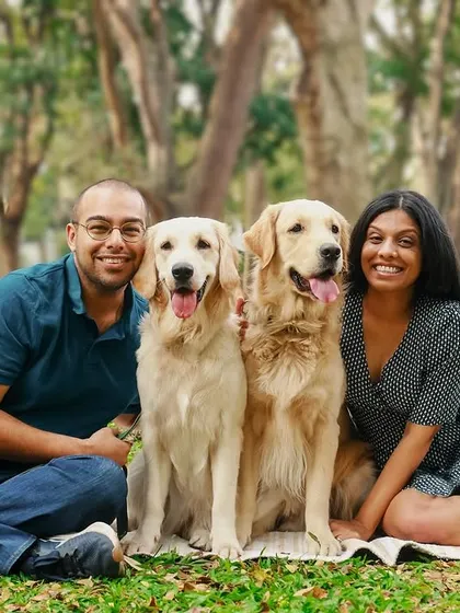 The perfect family portrait. This couple and their two gorgeous Golden Retrievers are all smiles during their outdoor session in the park.