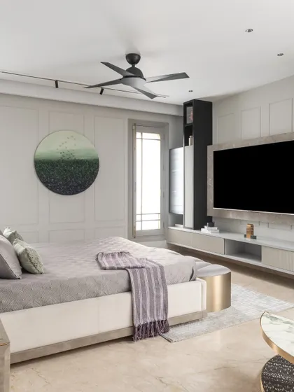 Another angle of the master bedroom, focusing on the TV wall and seating area. The design maintains a clean, uncluttered look while providing all the necessary comforts for a modern lifestyle.