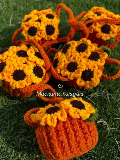 Our sunflower pot charms resting on the grass. They are perfect for adding a touch of nature-inspired decor anywhere you like.