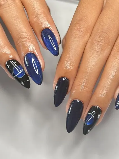 A galaxy at your fingertips. This celestial set features a deep blue cat-eye base and hand-painted planets and stars.