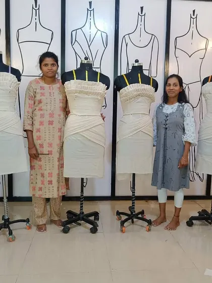 A group of students with their completed draping projects. This showcases their ability to create structured dresses using advanced techniques.
