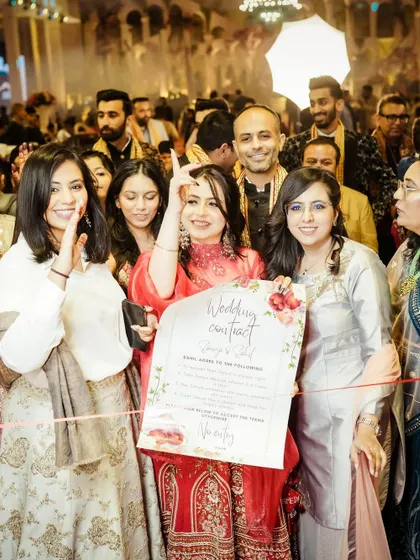 A fun wedding moment where the bride's friends present a "Wedding Contract" for the groom to sign.