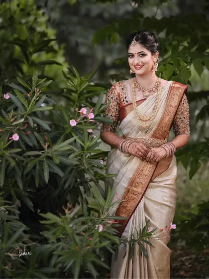 Our client looks stunning in her bridal attire, a classic silk saree that perfectly complements her grace and poise on her wedding day.