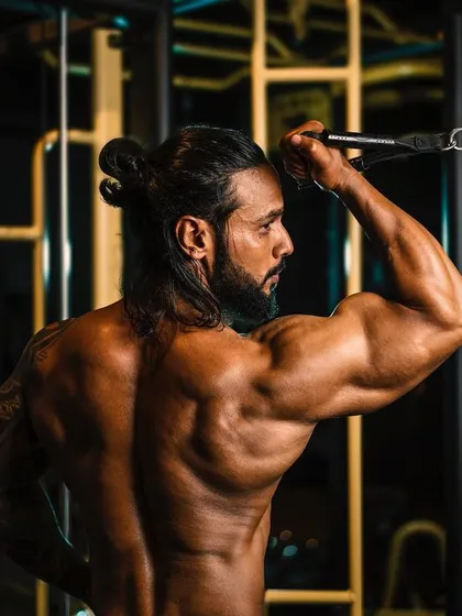 Building a strong back and defined arms with cable tricep pushdowns. Proper form here is key to sculpting the muscles.