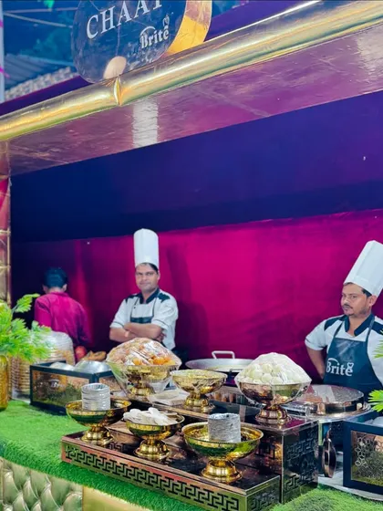 Chefs at the golden chaat counter, ready to customize snacks for guests.