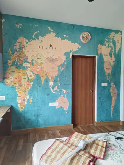 A vintage-style world map mural on a textured blue background, perfect for a study or older child's room.