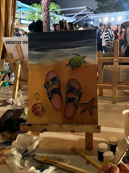 A finished painting from the Birkenstock event, showcasing the beachy, relaxed theme. It's a perfect memento from a fun day.