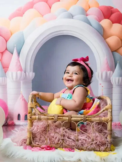Every princess deserves a castle. This colorful balloon castle setup creates a magical fairytale world for this happy baby girl.