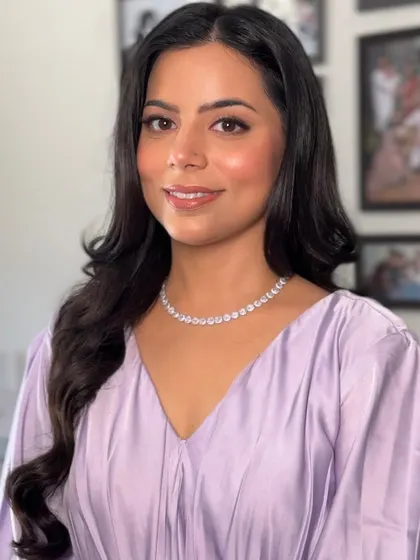 A final portrait in indoor lighting, showing how the makeup photographs beautifully. The skin looks smooth, hydrated, and luminous.
