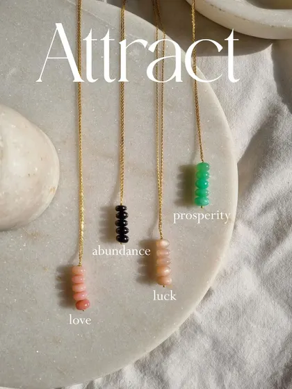 This image shows a variety of my pendants, including the hand-painted stork for luck, the Pink Opal drop for love, and the Black Onyx moon for protection against the evil eye.