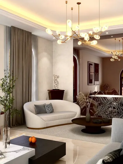 This living room features several of our custom curved sofas, arranged to encourage conversation. The organic shapes of the seating are juxtaposed with the sculptural, geometric forms of the chandeliers and the intricately designed bar counter in the background.