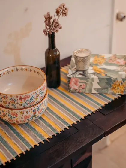 Another view of our striped table runner, adorned with floral bowls and a simple vase. This setup shows how our dining linen can be a versatile base for both everyday meals and special occasions.
