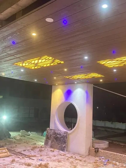The same ceiling at night. The backlit panels create a dramatic and luxurious effect, highlighting the potential of creative lighting in exterior design.