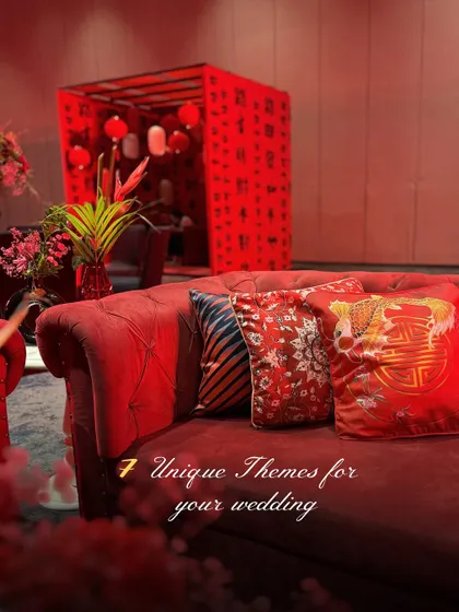 A glimpse into our "7 Unique Themes," with this image highlighting the rich textures and bold red of the Tokyo-inspired decor, featuring patterned cushions on a classic Chesterfield sofa.