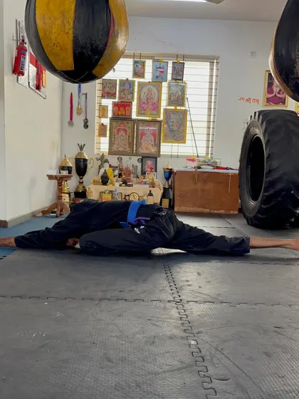 A deep stretching pose to improve hip flexibility, which is crucial for powerful kicks and grappling.
